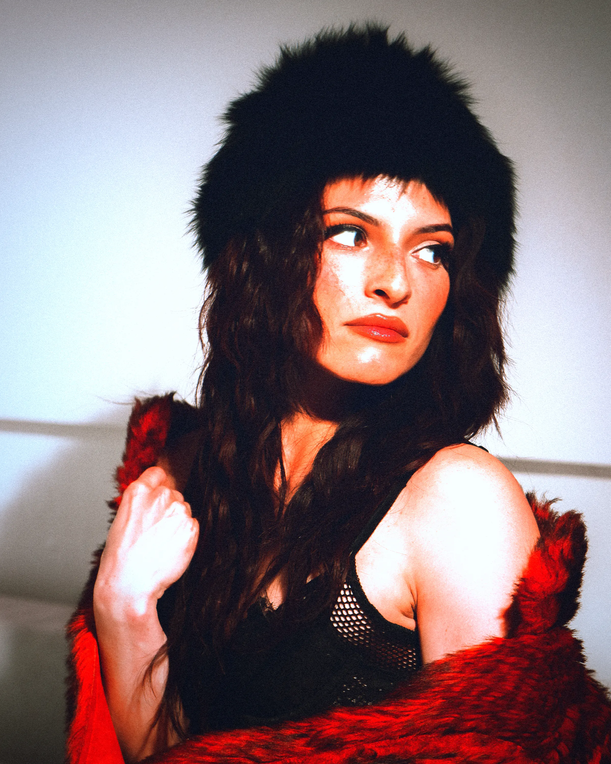 A woman in a fur hat under direct flash with a date stamp