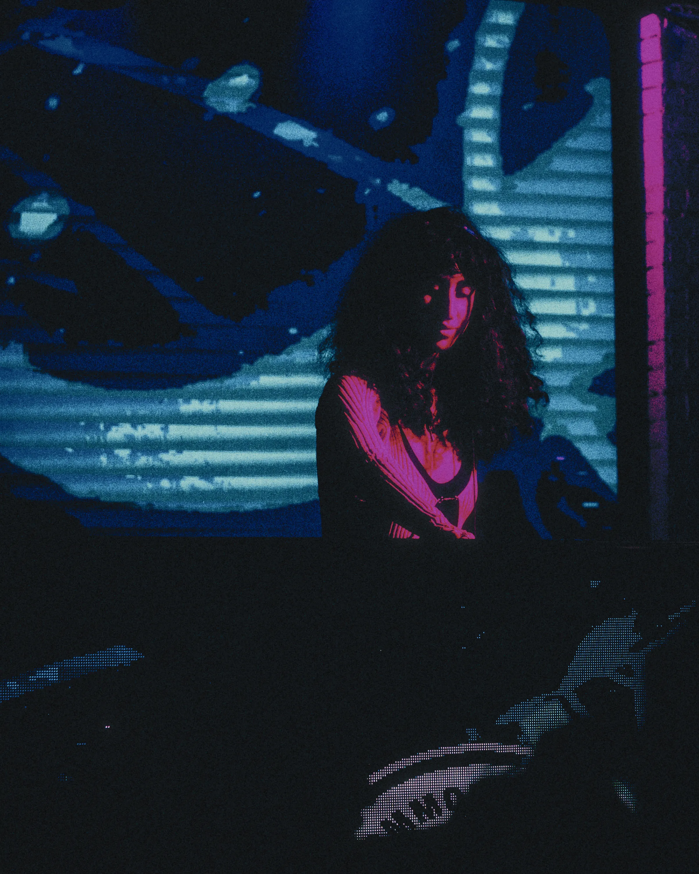 A singer in a dark club on tungsten cinema film
