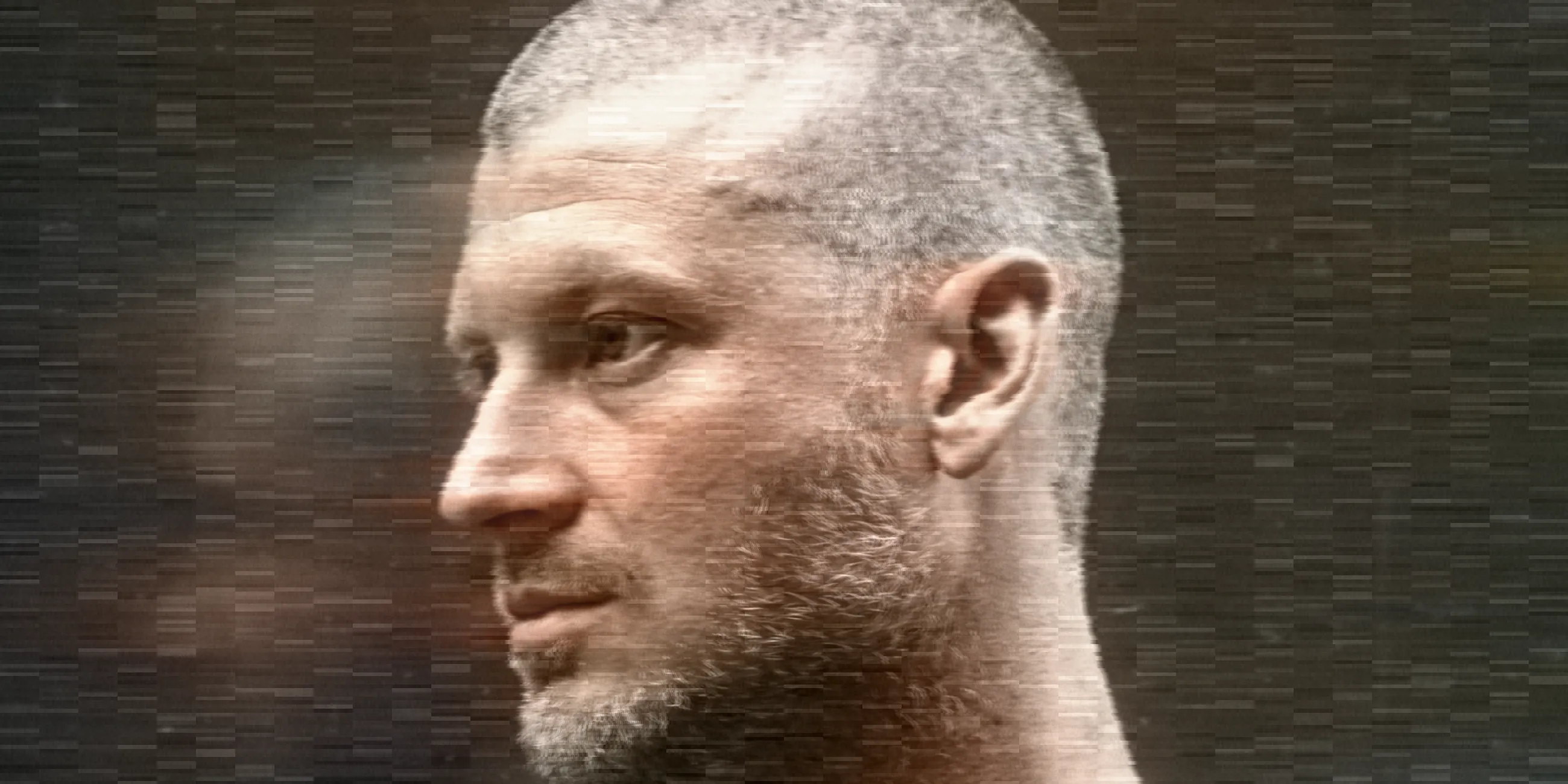 A man in profile as a paused VHS frame